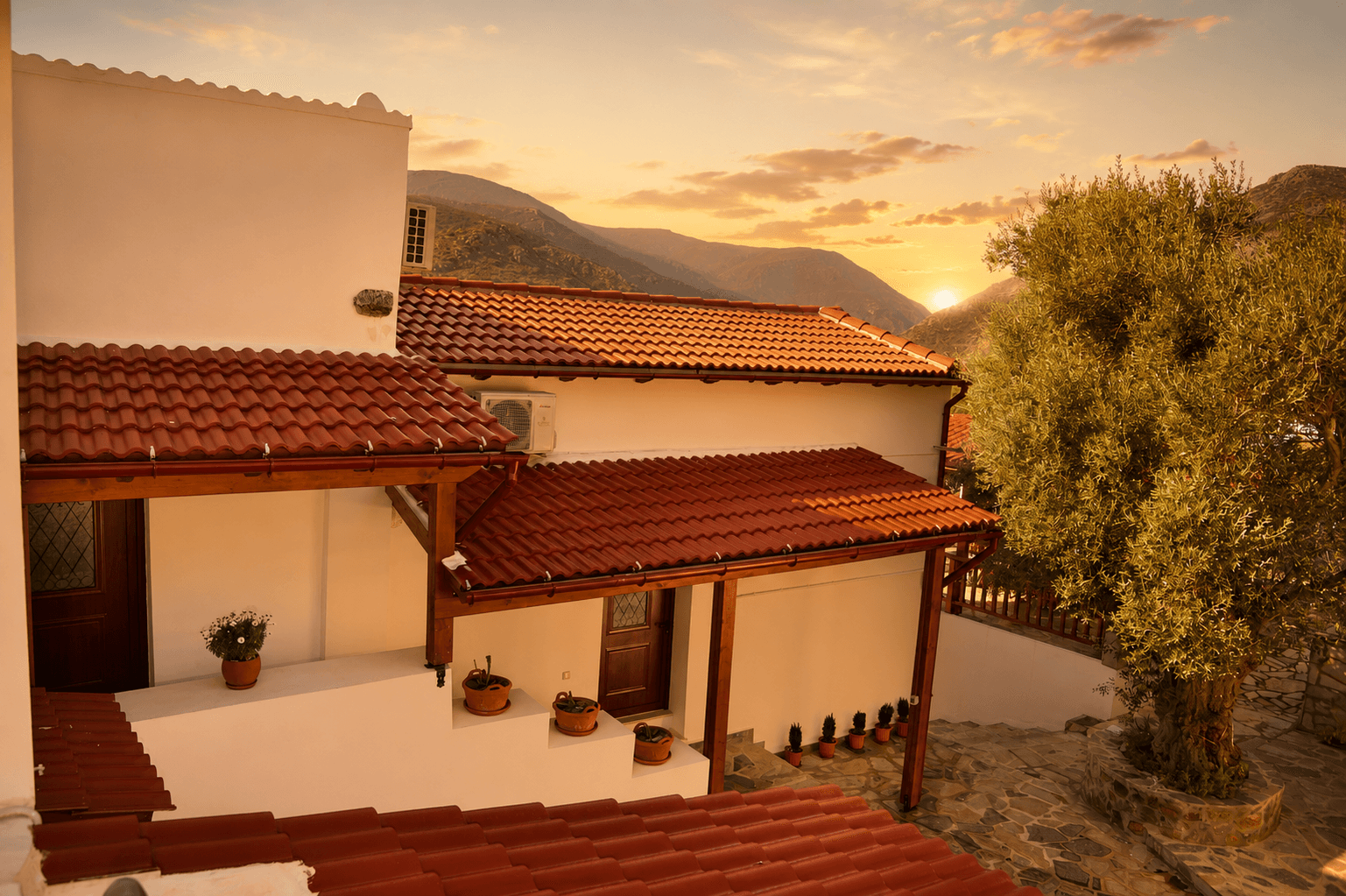 Plokamos House exterior — traditional Cretan stone architecture at sunset