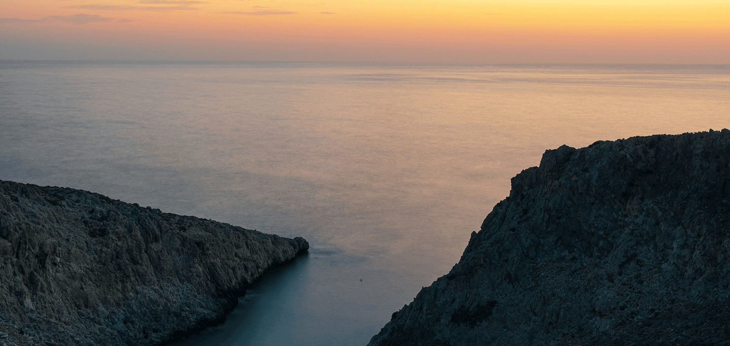 Sunset over the rocky coastline near Plokamos House