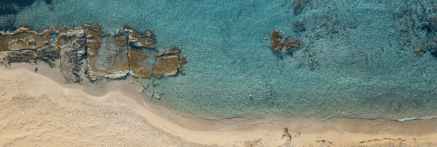 Aerial view of Crete's rocky coastline and turquoise sea